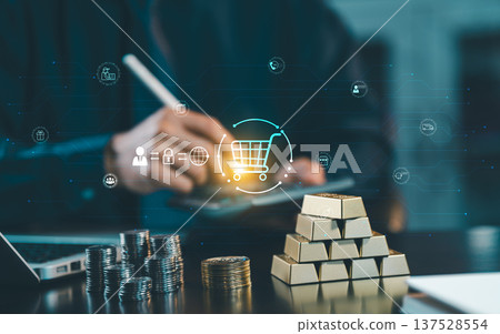Businessman using calculator with shopping cart icon, gold bars, and coins. Concept of digital economy, retail investment, financial planning, and e-commerce business growth. Businessman using calculator with shopping cart icon, gold bars, and coins. Concept of digital economy, retail investment, financial planning, and e-commerce business growth. 137528554