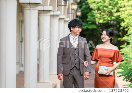 Couple in colorful dresses walking through the palace, married couple, bride and groom, dressed up couple, wealthy, wealthy Couple in colorful dresses walking through the palace, married couple, bride and groom, dressed up couple, wealthy, wealthy 137528752