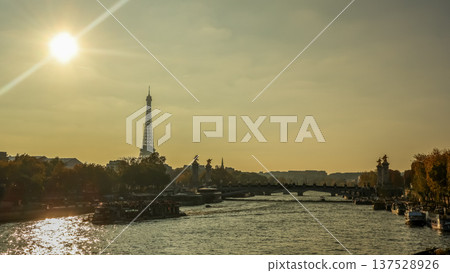 Paris cityscape with Eiffel Tower, Seine River, Pont Alexandre III, and tourist boats cruising at sunset 137528926