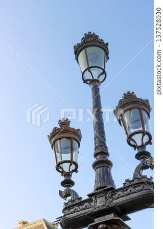 Grand Pont Alexandre III street lamp with multiple decorative lanterns adorning a classic Parisian bridge Grand Pont Alexandre III street lamp with multiple decorative lanterns adorning a classic Parisian bridge 137528930