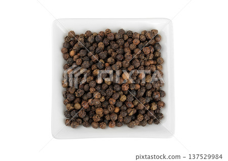 Black peppercorns or pepper in a ceramic bowl isolated on a white background. Top view. Flat lay 137529984
