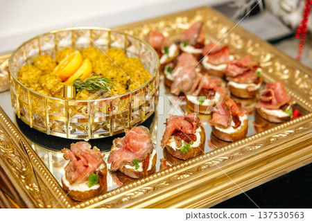 Appetizer platter serving roast beef bruschetta and cheese balls 137530563