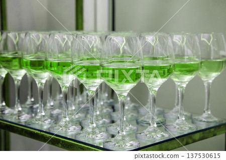 Green cocktails filling glasses arranged for celebration event Green cocktails filling glasses arranged for celebration event 137530615