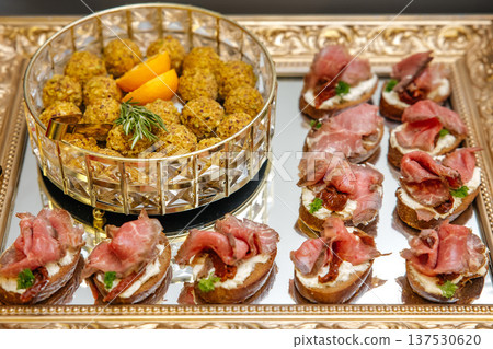 Appetizer platter presenting beef bruschetta and gourmet snack balls Appetizer platter presenting beef bruschetta and gourmet snack balls 137530620
