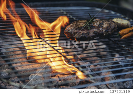BBQ Barbecue grilled meat stick on fire flame with hot charcoal cooking outside. Beef grilling picnic outdoor with smoke bacon spicy sausage for party. Grill pork bbq on fire flame BBQ Barbecue grilled meat stick on fire flame with hot charcoal cooking outside. Beef grilling picnic outdoor with smoke bacon spicy sausage for party. Grill pork bbq on fire flame 137531519