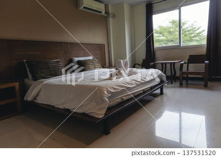 Blur background bedroom home interior in cozy decoration room. Clean soft bed stylish decor relax dorm with copy space. Modern apartment white light trendy style. Blurred background defocused indoors Blur background bedroom home interior in cozy decoration room. Clean soft bed stylish decor relax dorm with copy space. Modern apartment white light trendy style. Blurred background defocused indoors 137531520