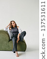 Happy Woman Sitting Green Sofa Leaning Forward 137531611