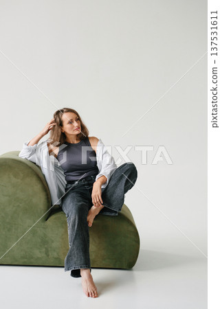 Happy Woman Sitting Green Sofa Leaning Forward Happy Woman Sitting Green Sofa Leaning Forward 137531611
