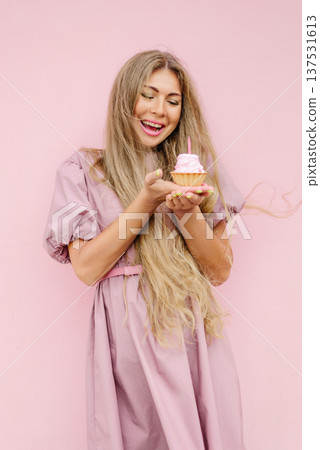 Joyful Woman Celebrating Birthday With Cupcake Joyful Woman Celebrating Birthday With Cupcake 137531613