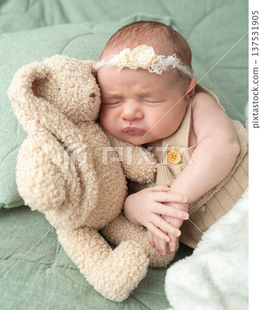 Calm infant resting in home environment with soft light and cozy atmosphere. Care focused scene supports lifestyle visuals and educational family related content. 137531905
