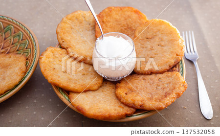 Crispy Potato Pancakes with Cream Topping Crispy Potato Pancakes with Cream Topping 137532058