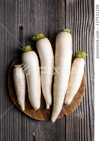 Fresh daikon radish arranged neatly on wooden table Fresh daikon radish arranged neatly on wooden table 137532108