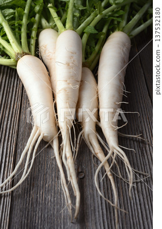 Whole daikon radish on rustic wood surface Whole daikon radish on rustic wood surface 137532180