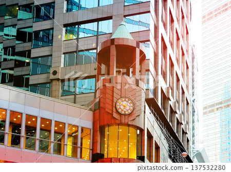 Clock tower on skyscrapers tower glass buildings in Hong Kong business district. 137532280