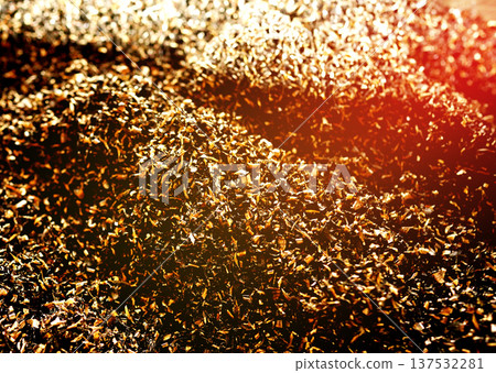 Golden steel scrap background. Gold chip waste after machining metal parts on a cnc lathe. 137532281