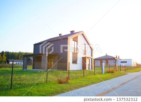 Suburban residential neighborhood, home on street, fence of single family home. Suburb family house. 137532312