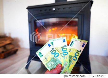 Heating payment. Save money wood stove. Euro money banknotes for payment of heating firewood. 137532353