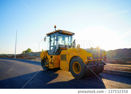 Road Asphalting construction. Asphalt paving repair. Vibrator compactor machine on roadworks. Road Asphalting construction. Asphalt paving repair. Vibrator compactor machine on roadworks. 137532358