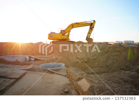 Excavator earthworks on construction site. Sewer line repair. Excavator groundwork water line repair Excavator earthworks on construction site. Sewer line repair. Excavator groundwork water line repair 137532363