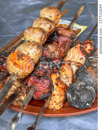 Grilled barbecue skewers with meat and roasted potatoes Grilled barbecue skewers with meat and roasted potatoes 137532644