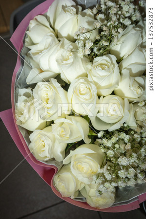 Elegant White Roses Bouquet with Gypsophila on Dark Background Elegant White Roses Bouquet with Gypsophila on Dark Background 137532873