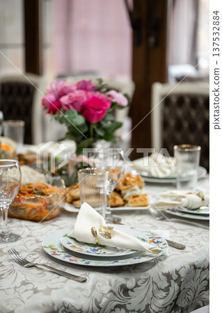 Elegant Dinner Table Setting with Pink Roses and Appetizers Elegant Dinner Table Setting with Pink Roses and Appetizers 137532884