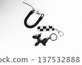 Black and White Checkered Flag and Balloon Dog Keychains on White Background 137532888