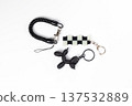 Black and White Checkered Flag and Balloon Dog Keychains on White Background 137532889