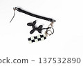 Black and White Checkered Flag and Balloon Dog Keychains on White Background 137532890