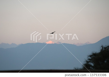A view of the Himalayan mountains shining white in the setting sun over the mountain range from the rooftop of a hotel in Kathmandu, Nepal A view of the Himalayan mountains shining white in the setting sun over the mountain range from the rooftop of a hotel in Kathmandu, Nepal 137533306