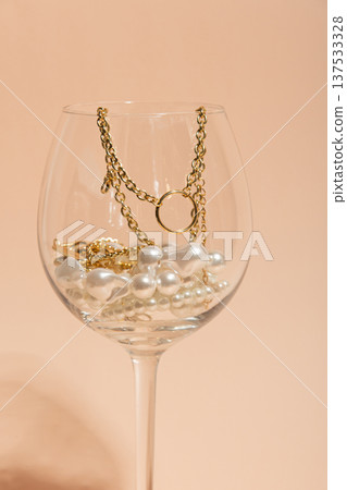 Pearls And Chains Display. Decorative Collection Of Pearls And Gold Necklaces Inside Glass Container 137533328