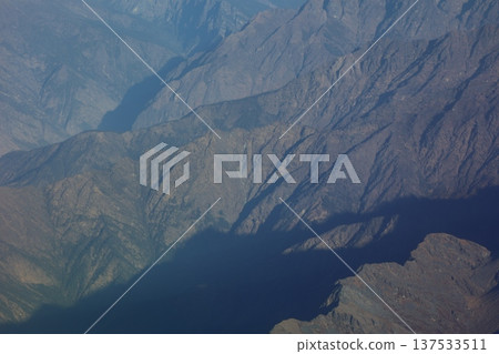 A view of the green mountain range from the window of a mountain flight airplane A view of the green mountain range from the window of a mountain flight airplane 137533511