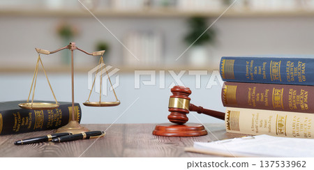 Legal Background with Scales and Law Books. A lawyer's desk featuring legal texts and a gavel. Legal Background with Scales and Law Books. A lawyer's desk featuring legal texts and a gavel. 137533962