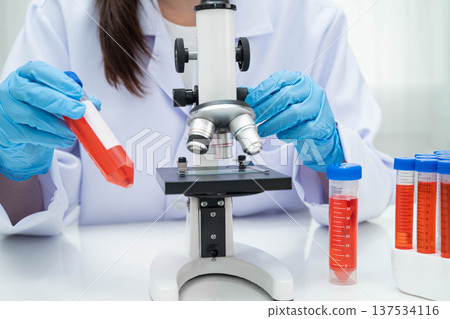 Scientist medical professional use microscope for research in science laboratory. Scientist medical professional use microscope for research in science laboratory. 137534116