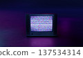 Retro Style Old TV Set with TV static on screen. Vintage 80s analog television with grain and No signal white noise. Broken television. Purple Neon Background. For mock up VFX compositing. 137534314
