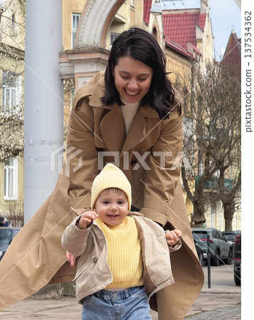 Mother and toddler under blossoming tree Mother and toddler under blossoming tree 137534362
