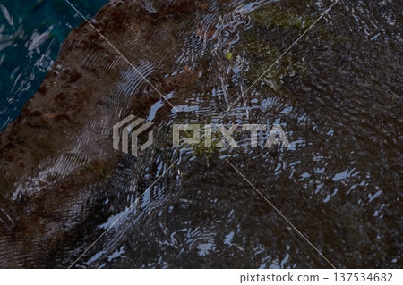 Clear water flowing down the rock surface Clear water flowing down the rock surface 137534682