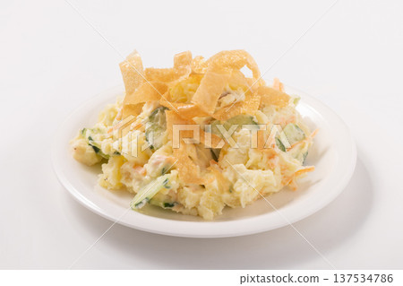 Potato salad and fried spring roll skins 137534786