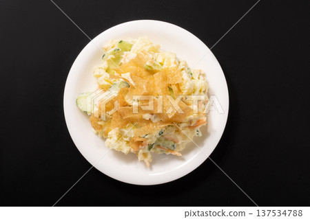 Potato salad and fried spring roll skins 137534788