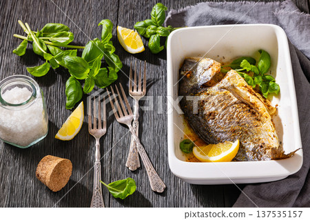 Baked whole dorada fish with lemon and basil Baked whole dorada fish with lemon and basil 137535157