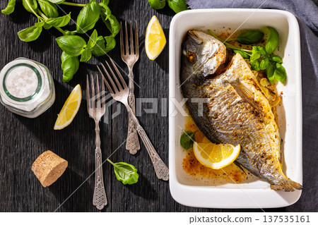 Baked whole dorada fish with lemon and basil Baked whole dorada fish with lemon and basil 137535161