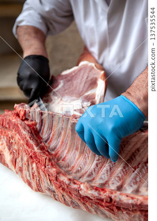 The butcher's work on the shop's chopping block 137535544