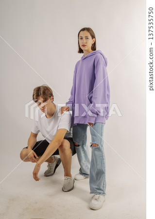Beautiful young guy and girl in stylish clothes on 137535750