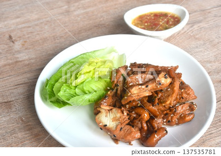 salty steamed slice chicken meat with white sesame in soy sauce on plate dipping spicy and sour chili sauce 137535781