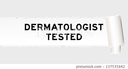 Ripped gray paper background that have word dermatologist tested under torn part 137535842