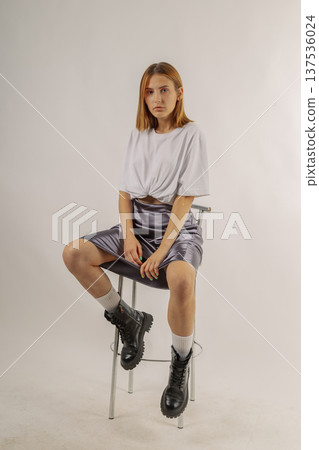 Beautiful young girl in fashionable clothes on 137536024