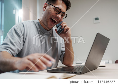 Person Chuckles During Online Work. Someone Smiles While Participating In Digital Team Discussion Person Chuckles During Online Work. Someone Smiles While Participating In Digital Team Discussion 137536227