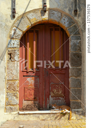 Old wooden door with stone arch and cat in Rhodes Greece 137536876