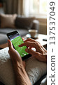 Hands Using Smartphone to Watch Soccer at Home 137537049