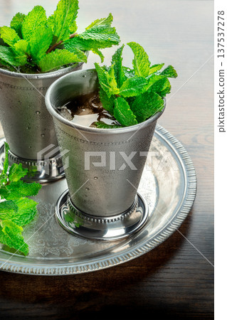 Mint Julep in the Kentucky Derby classic silver glass, with fresh mint leaves 137537278